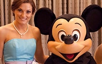 A bridesmaid poses with Mickey Mouse