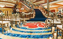 A long stairway with flower decorated bannisters leads to a large room lined with rows of chairs