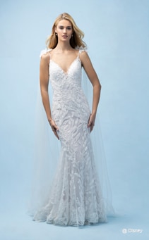 A bride wearing a Rapunzel inspired sheath gown featuring a V neckline and lace detail