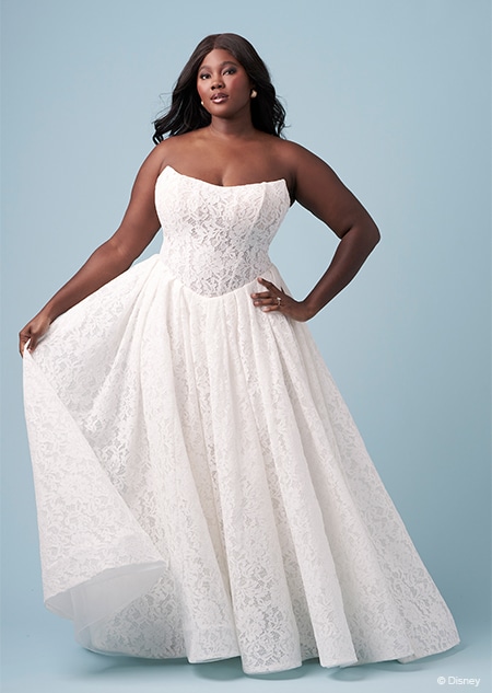 A bride wearing a strapless Snow White inspired A line gown featuring a scoop neckline