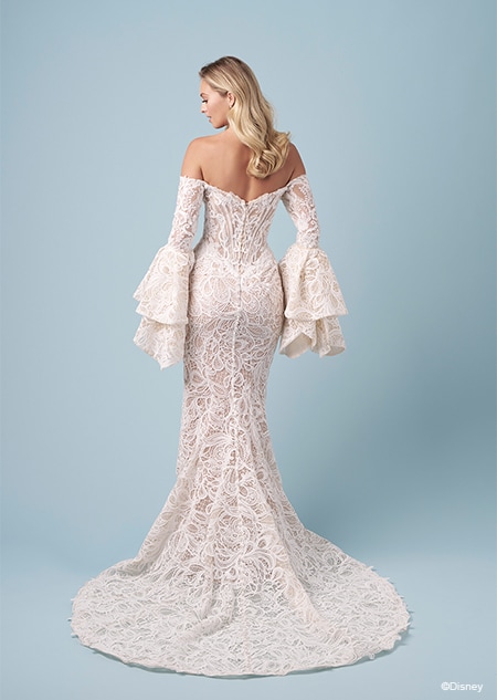The back of a bride wearing a strapless Jasmine inspired mermaid wedding gown featuring lace and ruffled off the shoulder sleeves