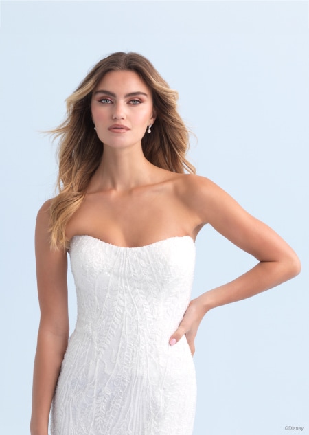 The back of a strapless wedding dress inspired by Ariel from The Little Mermaid featuring a long trail The back of a strapless wedding dress inspired by Ariel from The Little Mermaid featuring a long trail