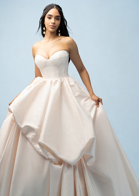 The front of a bride wearing a Belle inspired ball gown featuring a sweetheart neckline