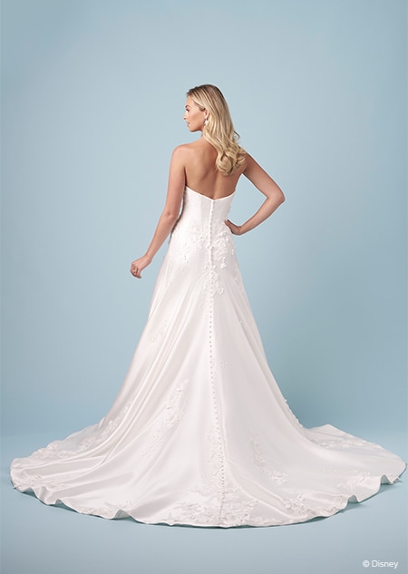 The back of a bride wearing a strapless Aurora inspired A line gown with embroidered flowers