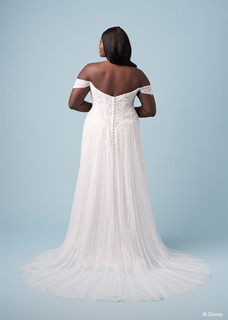 The back of a bride wearing a Jasmine inspired sheath gown featuring off the shoulder sleeves and an embroidered bodice