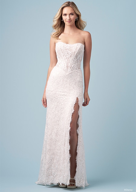 A bride wearing a strapless Snow White inspired sheath dress featuring an embroidered bodice and a high slit