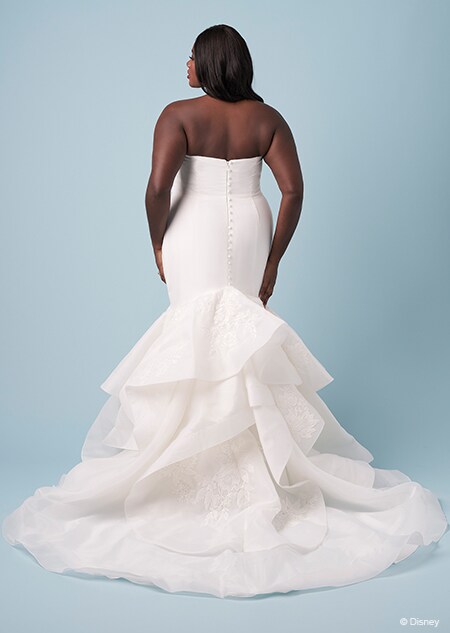 The back of a bride wearing a strapless Tiana inspired trumThe back of a bride wearing a strapless Tiana inspired trumpet gownpet gown