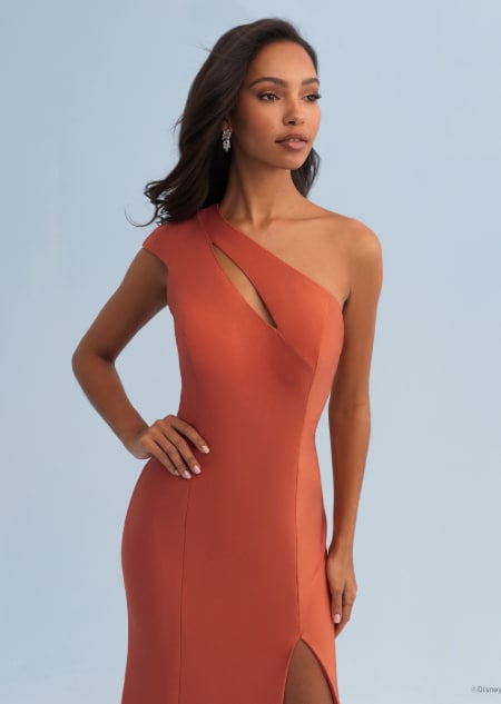 A woman wearing a Pocahontas themed bridesmaid dress with an asymmetrical neckline