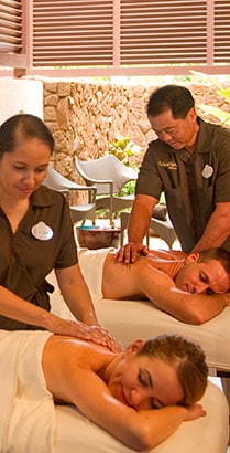 A man and woman receive a couples massage at Laniwai Spa at Aulani