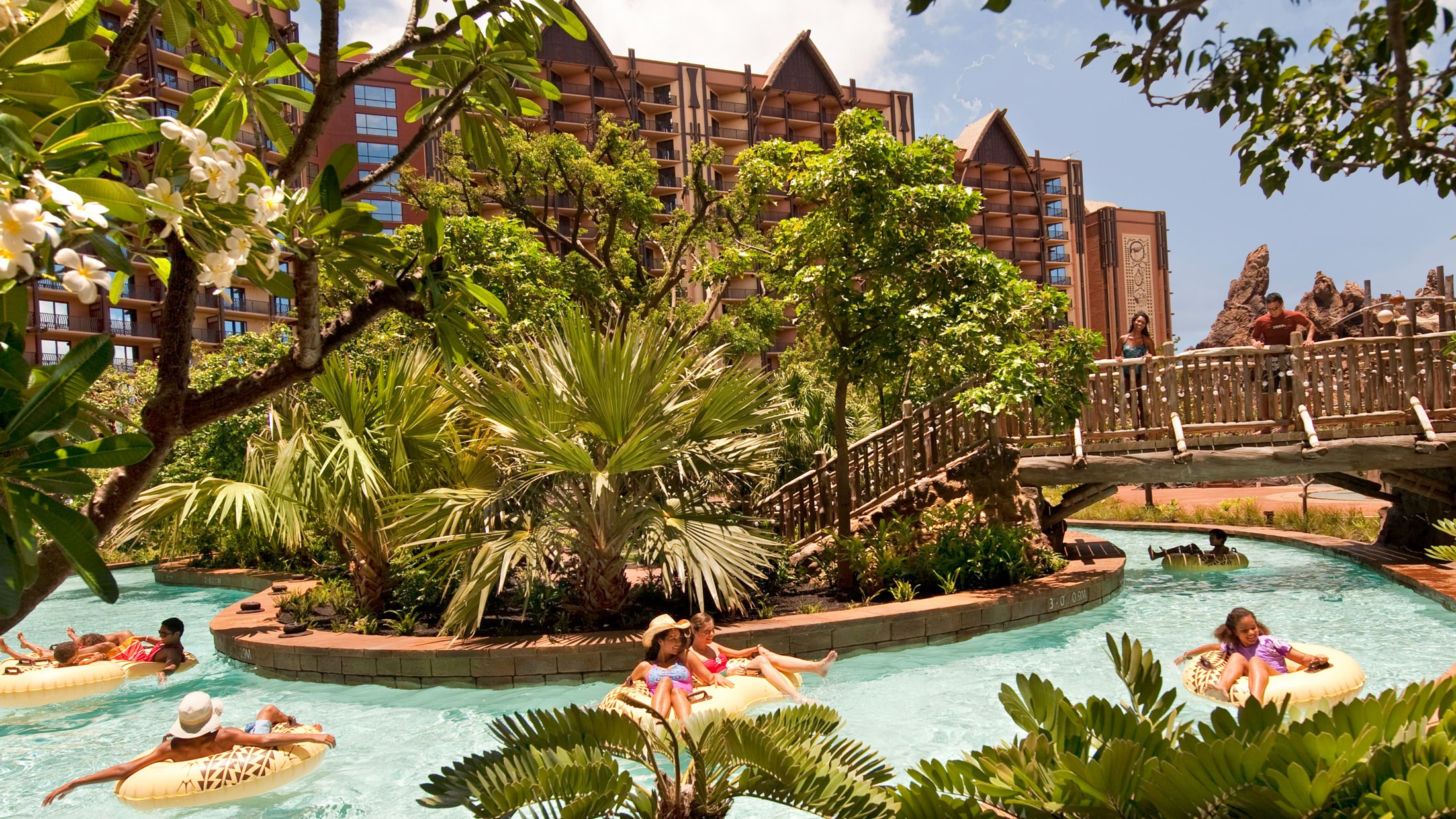 Several people on floats, drifting along the pool area's lazy river