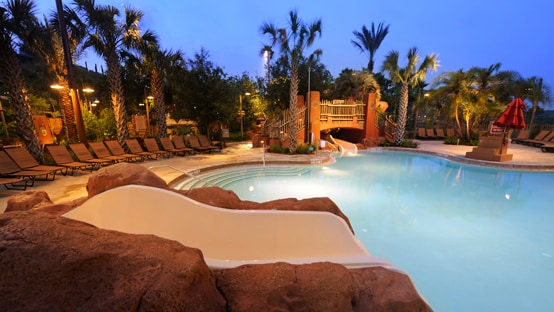 A swimming pool at Disney's Animal Kingdom Lodge, illuminated at night