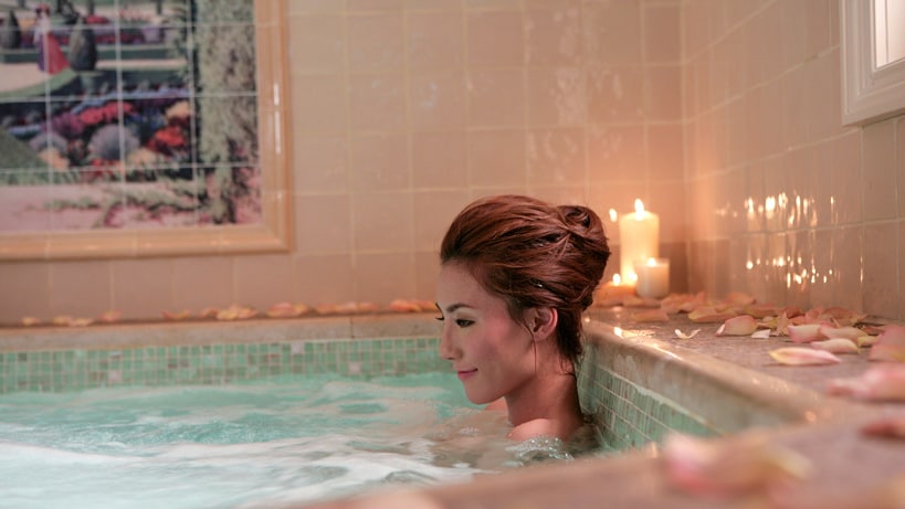 A woman relaxing in a whirlpool spa at Hong Kong Disneyland Hotel