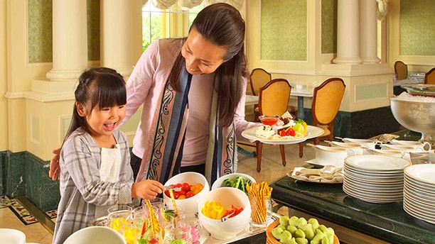 A woman and her daughter at the buffet of Sherwood Garden Restaurant