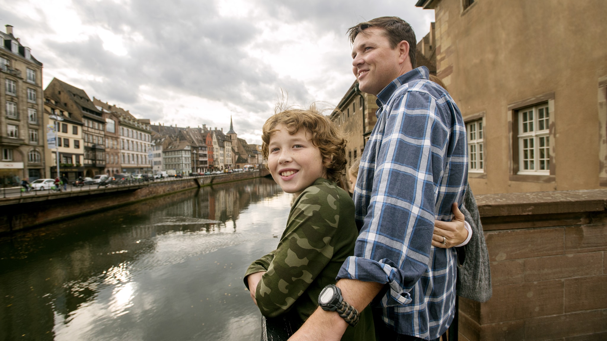 A father and son standing beside the Rhine River