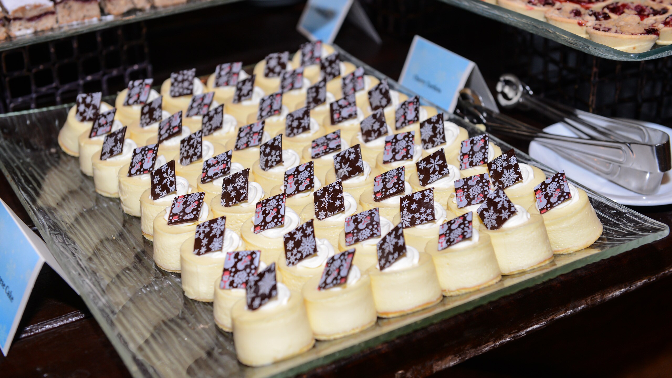 A tray filled with mini cheesecakes A tray filled with mini cheesecakes