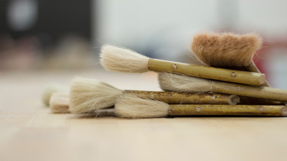 Several clean paint brushes on a countertop