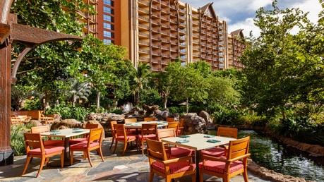 An outdoor dining area overlooking a small pond at Aulani, A Disney Resort & Spa