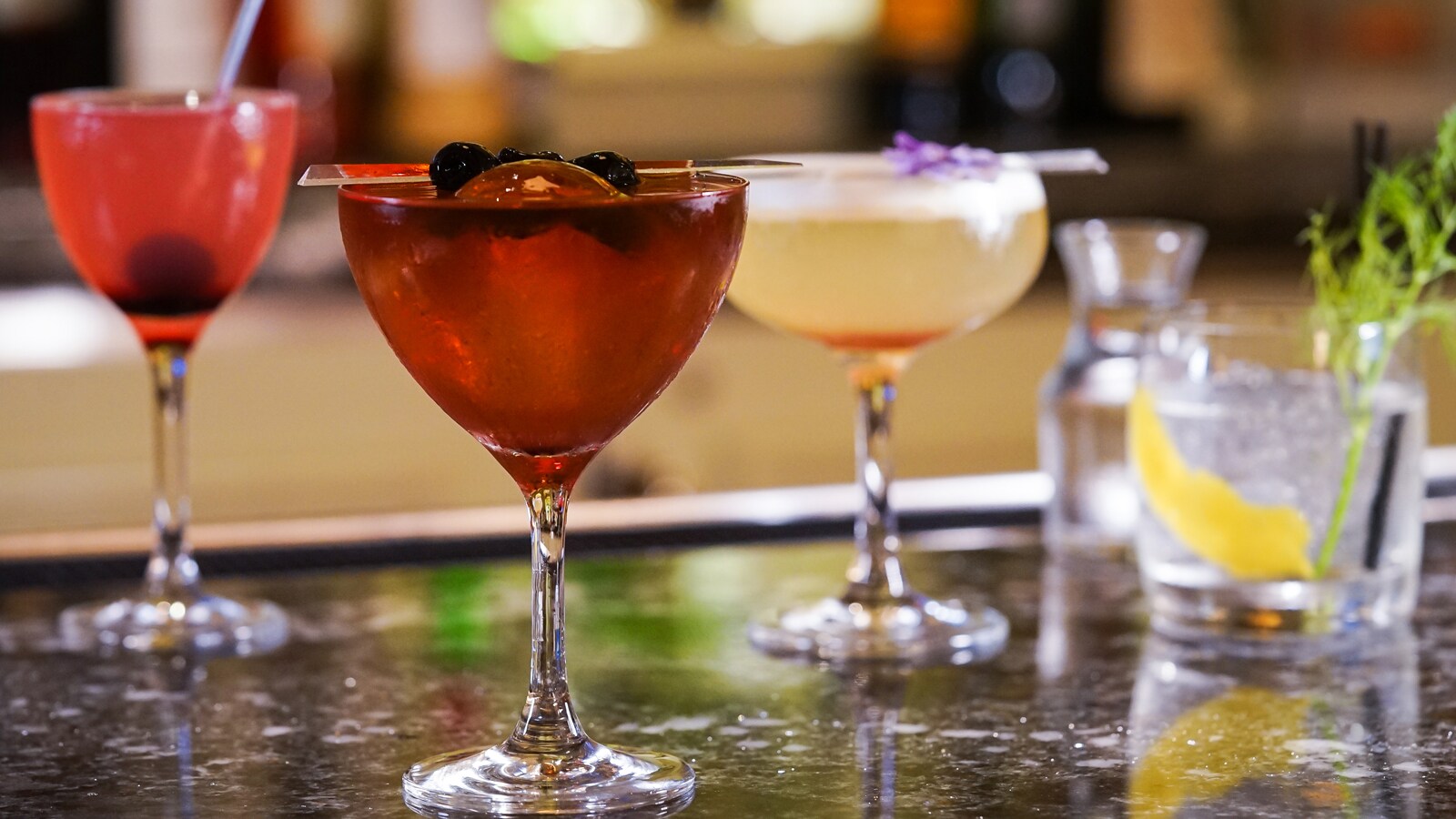 4 cocktails on a bar top
