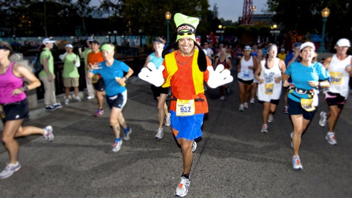 A man running a race, dressed in a Goofy costume