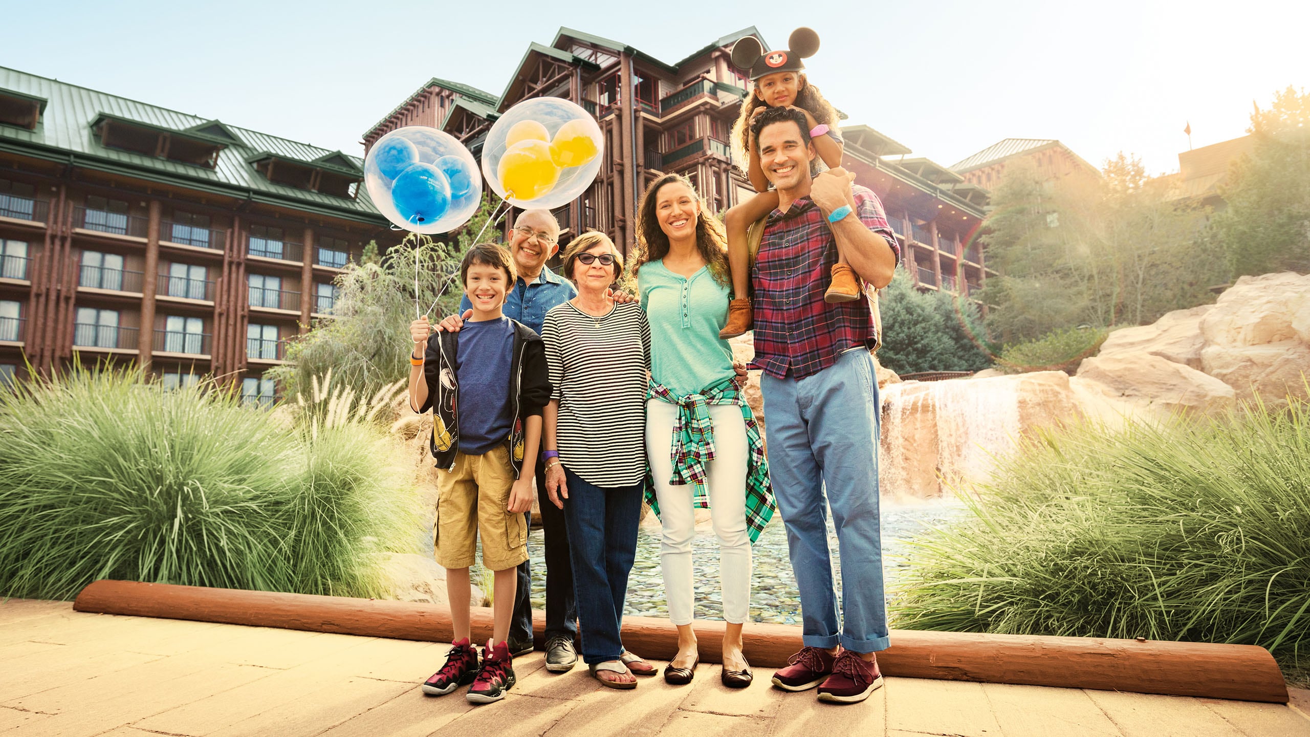 A family of 4 standing by the fountain at Disney's Wilderness Lodge