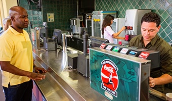 Guests serve themselves at a self-serve beverage counter