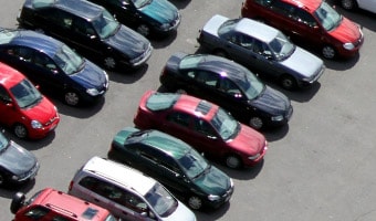 Two rows of cars parked in a parking lot