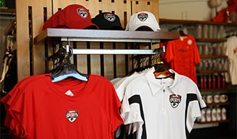 A rack filled with t shirts and caps at ESPN Wide World of Sports in Walt Disney World Resort