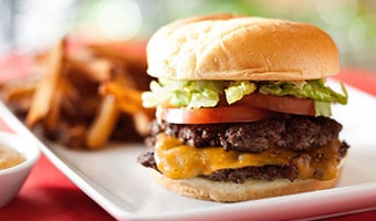 More Dining Options A cheeseburger with 2 patties, lettuce and tomato and fries