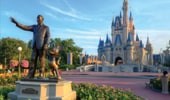 Statue of Walt Disney and Mickey Mouse in front of Cinderella's Castl