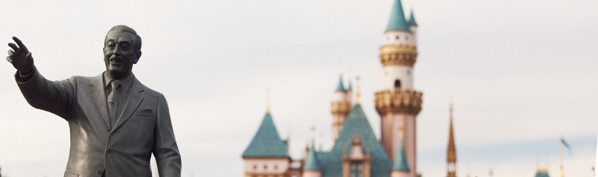 Statue of Walt Disney in front of Sleeping Beauty Castle